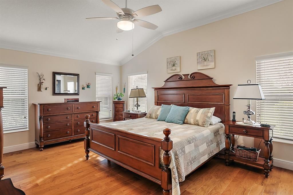 Master bedroom with crown molding and engineered hardwood flooring
