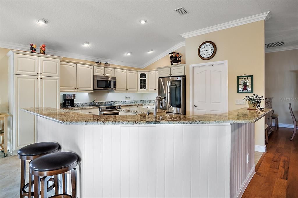 Kitchen with generous breakfast bar and crown molding