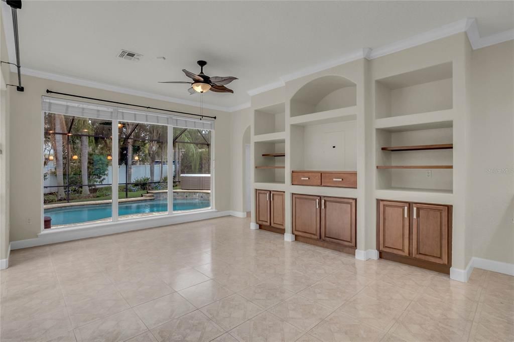 Great Room features Built-in entertainment center and pool views