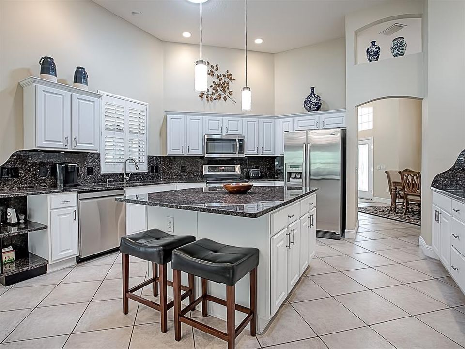 STAINLESS APPLIANCES, POT DRAWERS AND A CONVENIENT PASS-THRU WINDOW OUT TO THE POOL AREA!