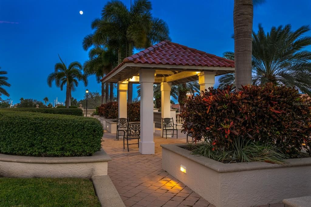 Evening stroll through the outdoor amenities level with lush landscaping and a lovely pergola for visiting with your neighbor