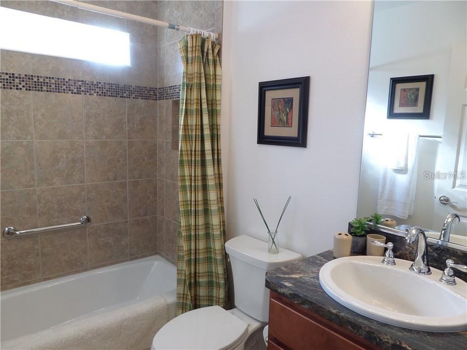 Lovely Guest Bathroom with transom window and tiled shower