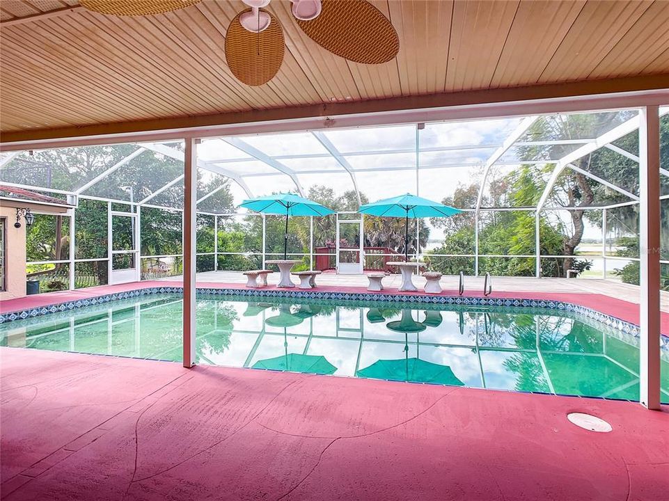 Beautiful covered lanai, with large pool and screened in patio over looking the lake.