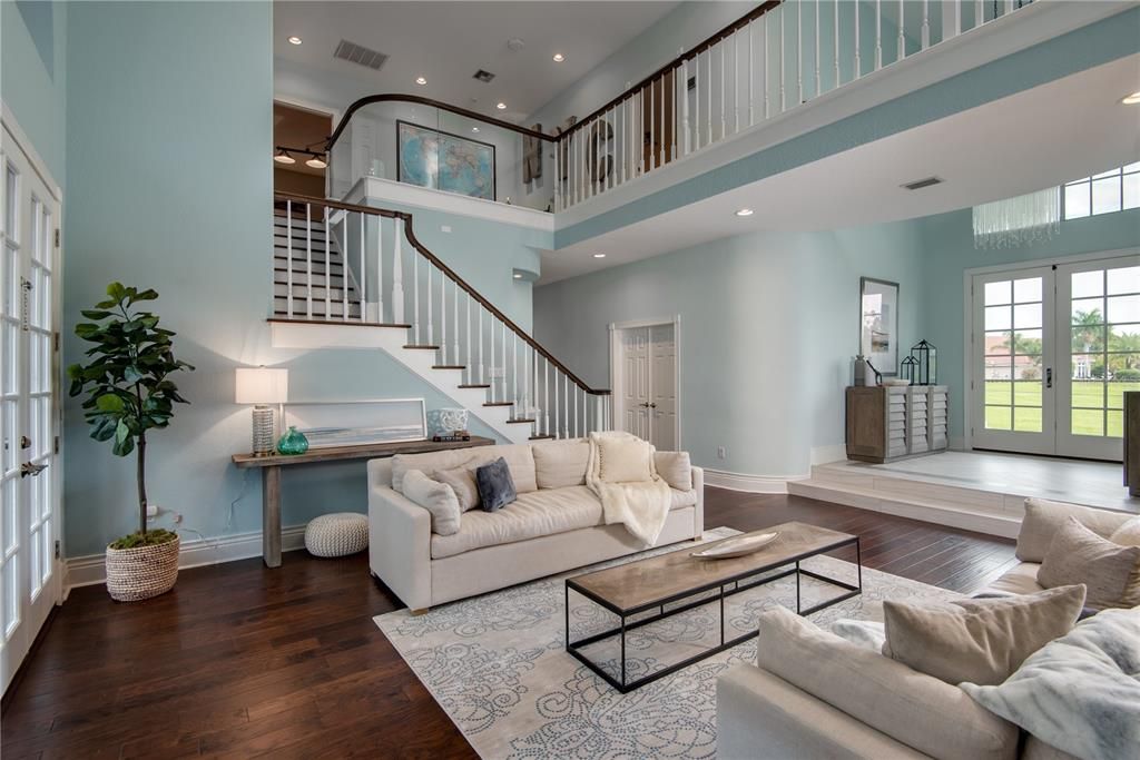 Beautiful formal living room - stairs to the second level where the theater, game room and ensuite are located.