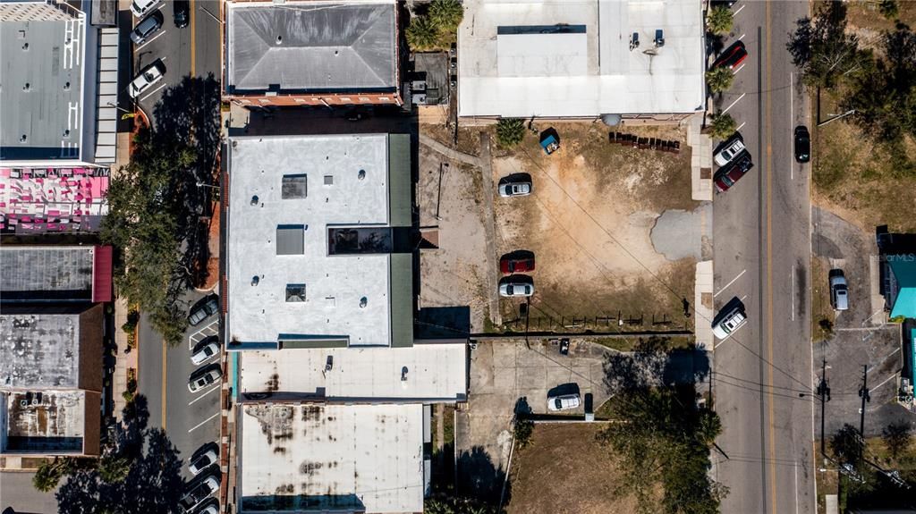 Aerial of building and two lots used for parking