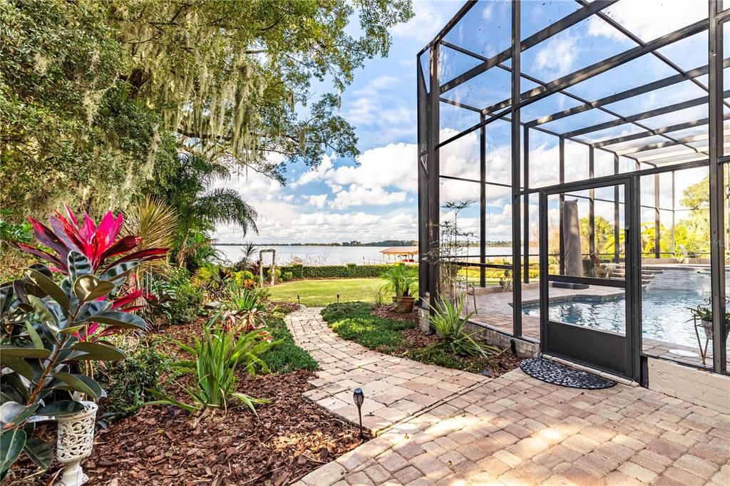 Paver Walkway to Garden & Back Yard with Side Outside Entrance to Pool and Deck