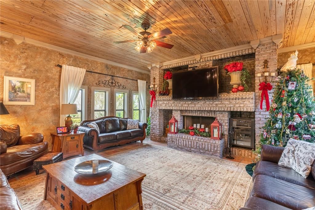Family Room with Amazing Brick Fire Place with Custom Built In Shelving