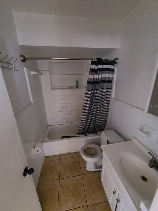Bathroom with a tub with shower