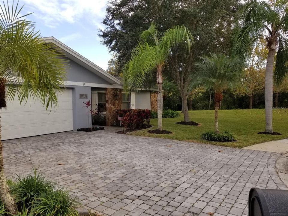 Front of House with brick pavers on driveway and view of gigantic Side Yard