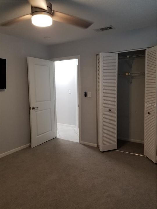 Bedroom 2 has ray carpet and bi-fold closet doors