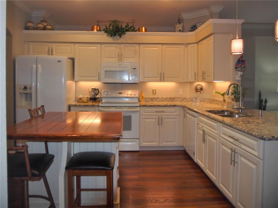 Upgraded cabinetry in kitchen with granite countertops