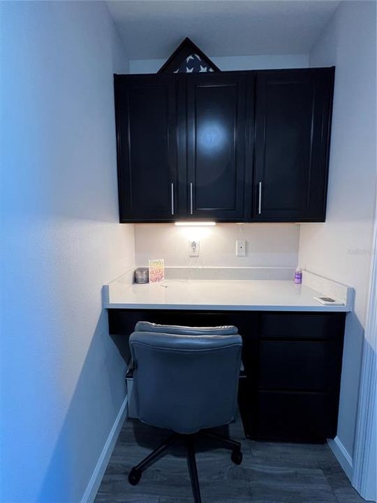 Hall niche with built in desk and cabinets with under cabinet lighting.