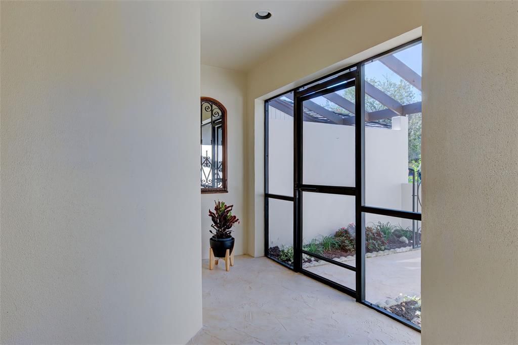 Large, covered and screened entryway.