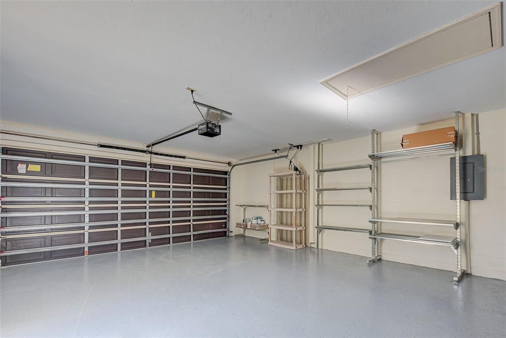 Oversized (2) car garage with lots of shelving and storage. Neat and clean. New tankless water heater, a/c (3) years old and ample storage space in the attic.