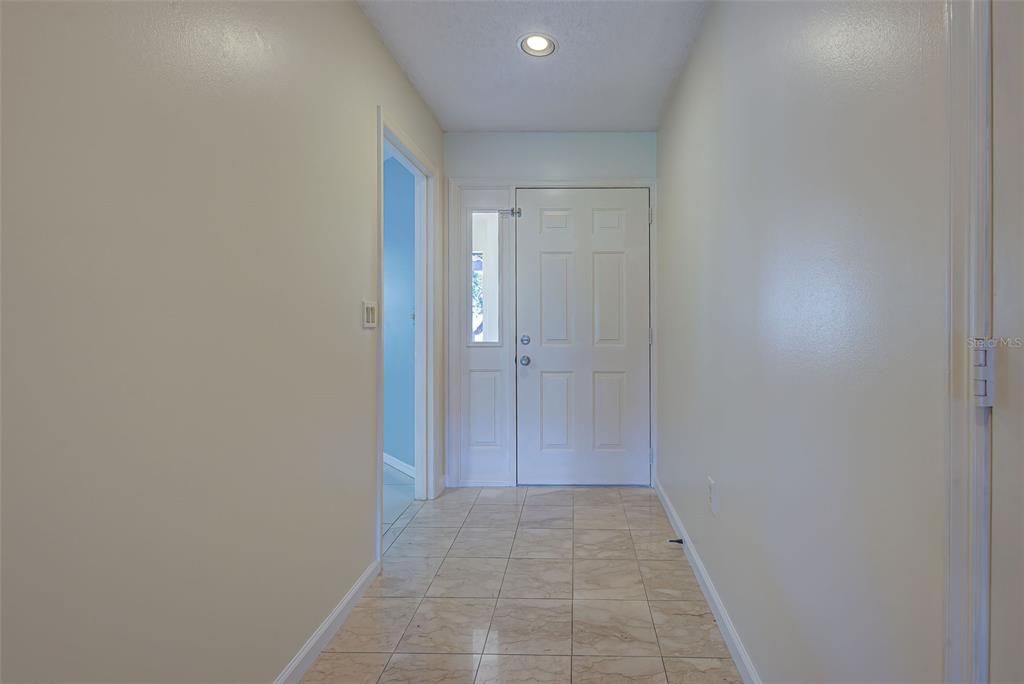 Entry hallway with marble flooring