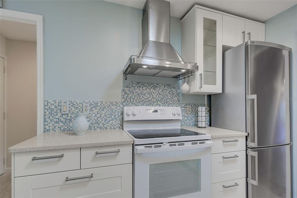 Stainless steel range hood that vents to the exterior. So very elegant