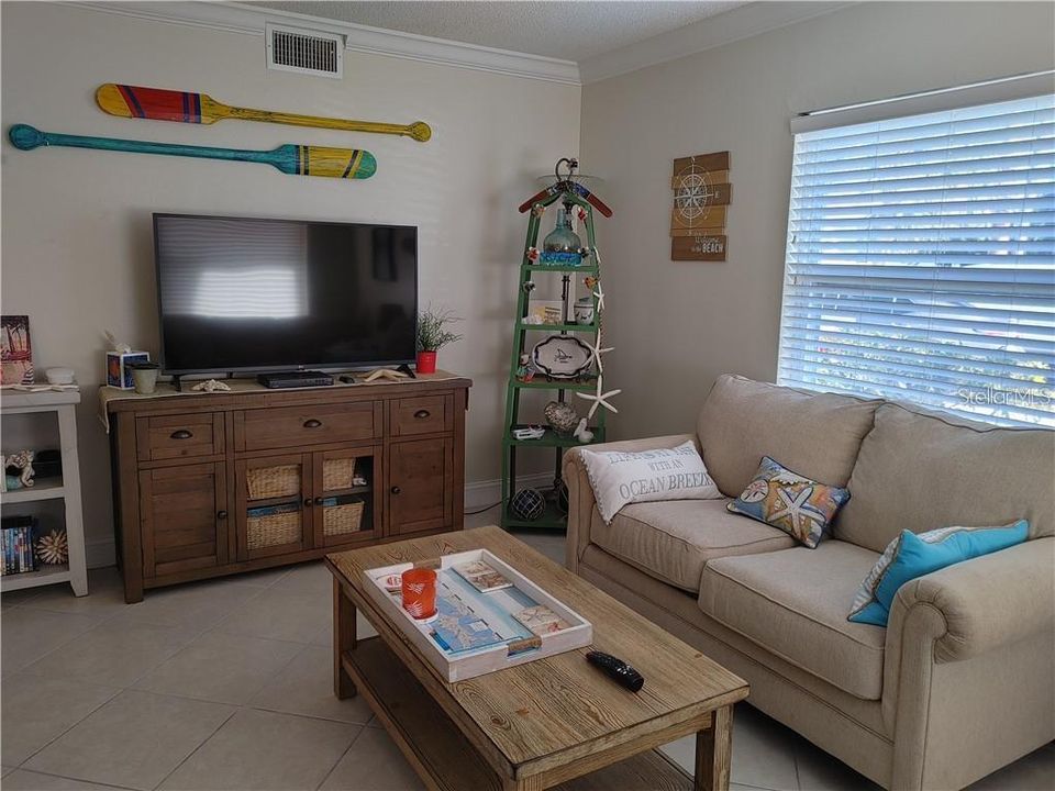 Walk into a beachy great room with a fold out sofa, cable TV and Roku streaming, Wi-Fi