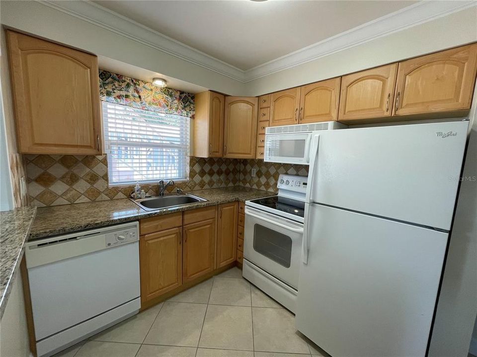 Full kitchen with refrigerator, range, microwave, dishwasher and garbage disposal