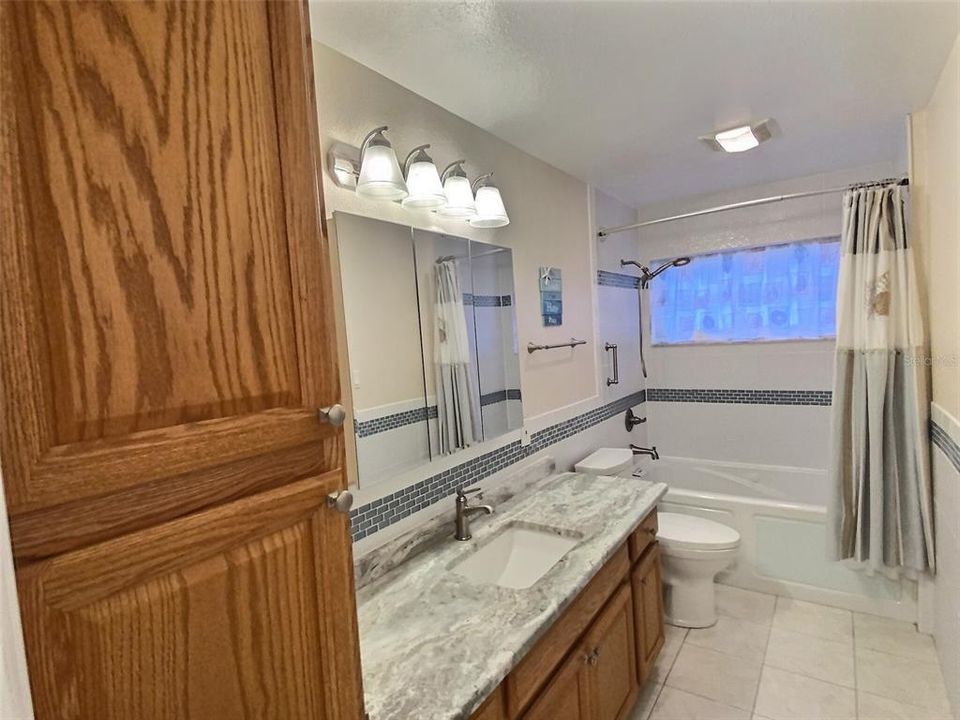 Owner's Bath with jetted tub, tons of cabinets, and huge granite countertop