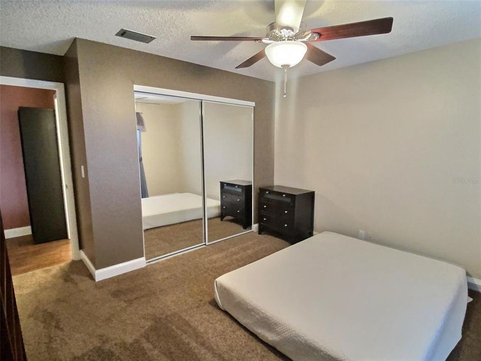 Guest room with brand new carpeting and large closet with mirrored sliding doors