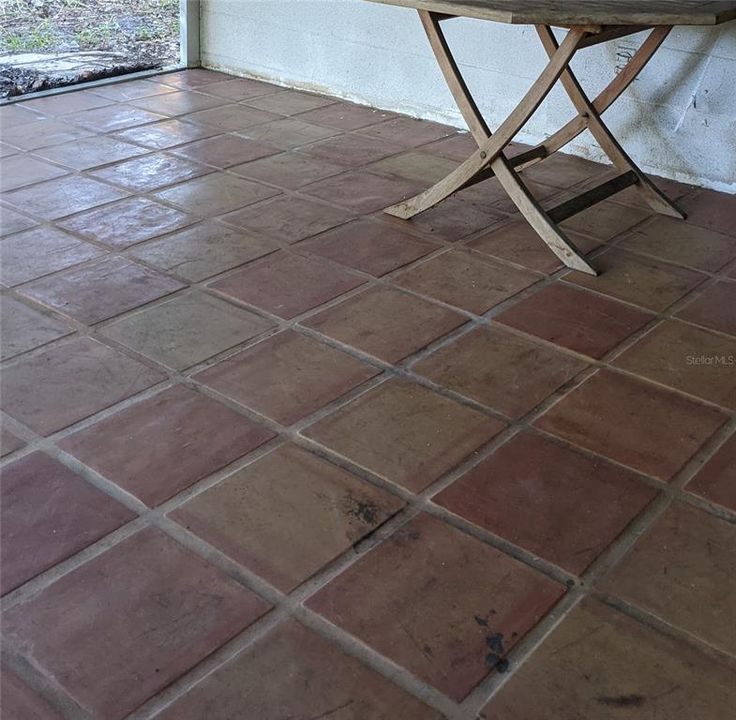 Mexican Tile flooring on rear screened in patio that walks out from Florida Room.