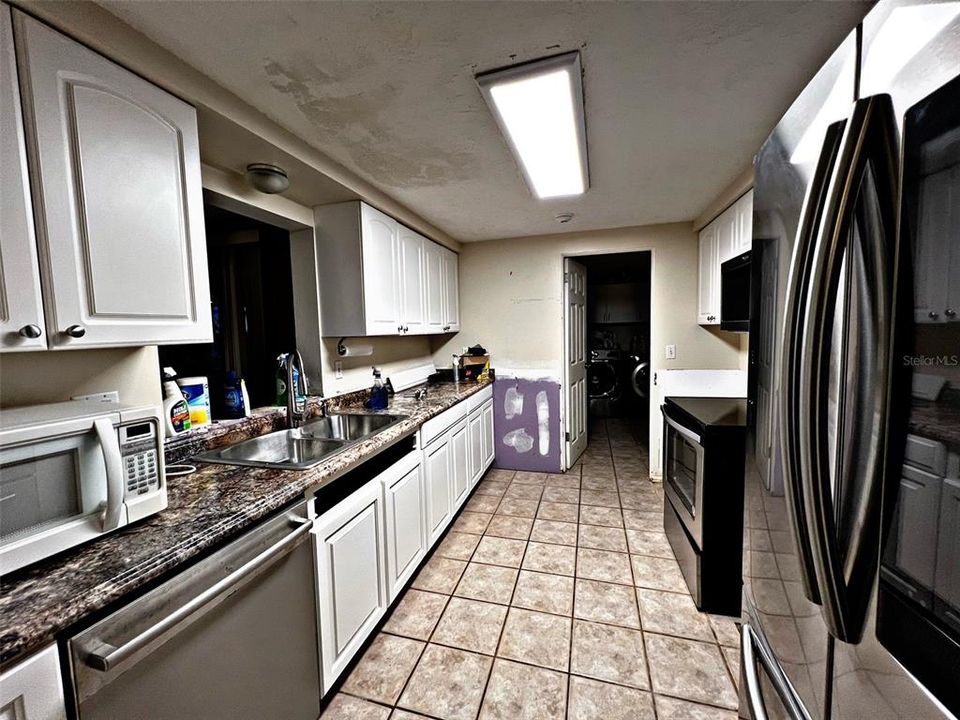 Galley Kitchen with opening to Florida Room over sink.