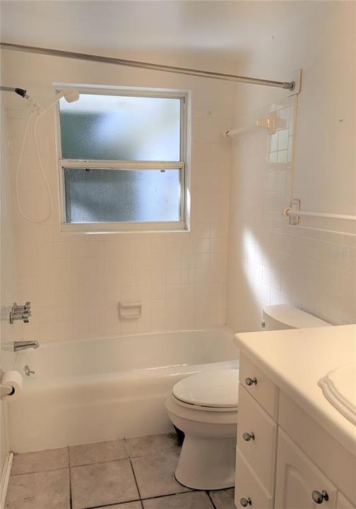 Bathroom No. 1 has shower-tub and ceramic tile floors