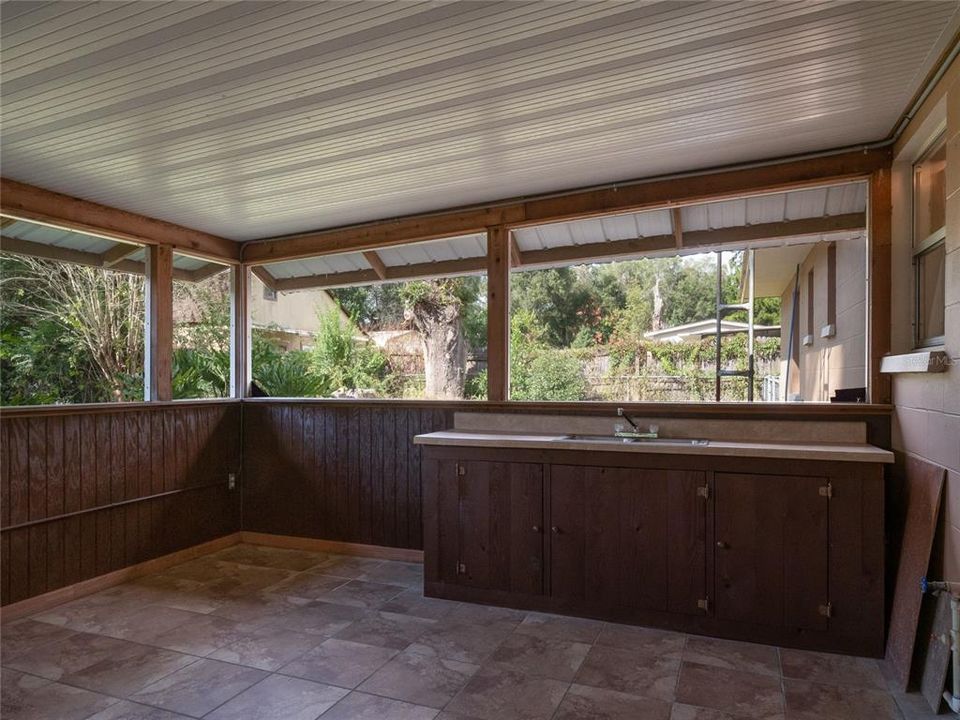 Enclosed back porch with sink bring your friends and relax.