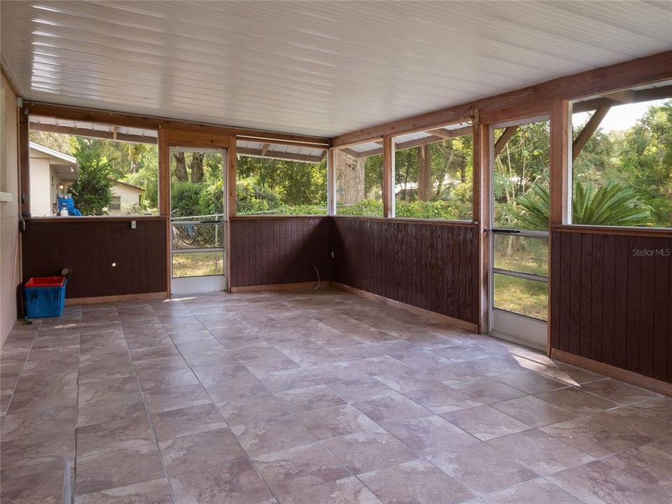 Huge enclosed back porch/lanai with sink perfect for entertaining.