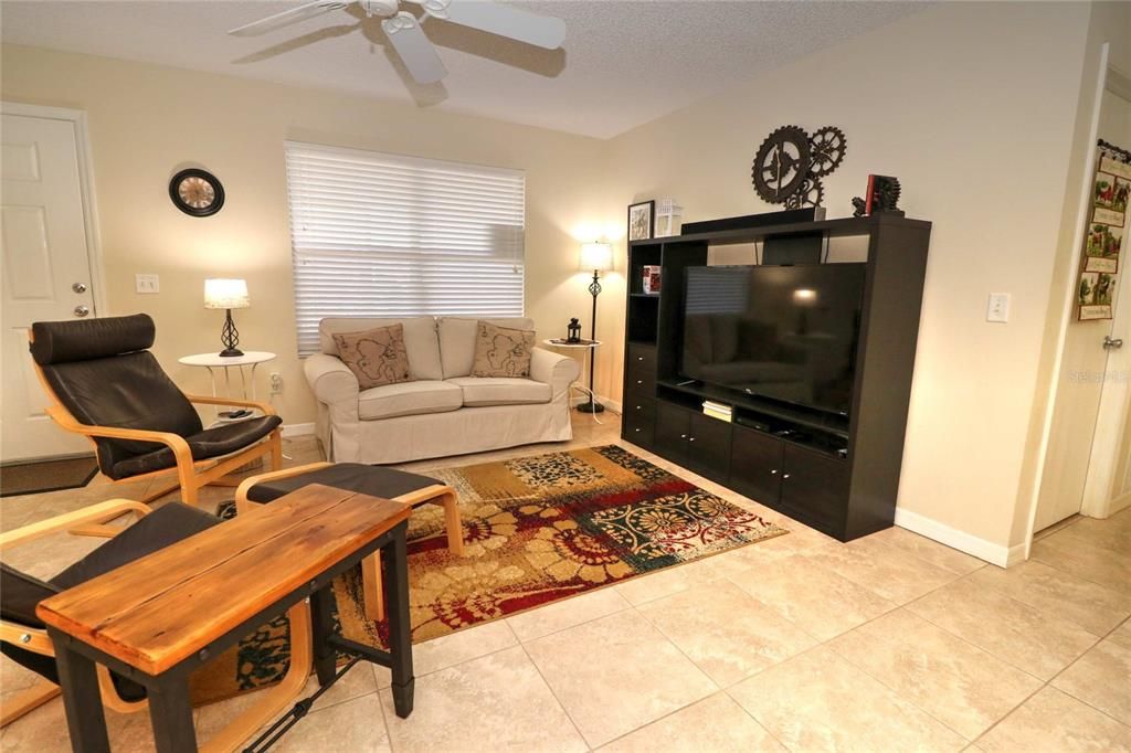 The living room has plenty of room for the love seat ( stays) and a couple of chairs ( these do not stay), a sofa also works nice as do two recliners.  The rug , entertainment, some wall decor and tv all stay.