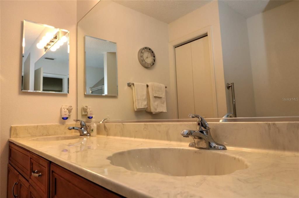 There are double cultured marble sinks in the Master Bathroom, a large mirror and a linen closet.