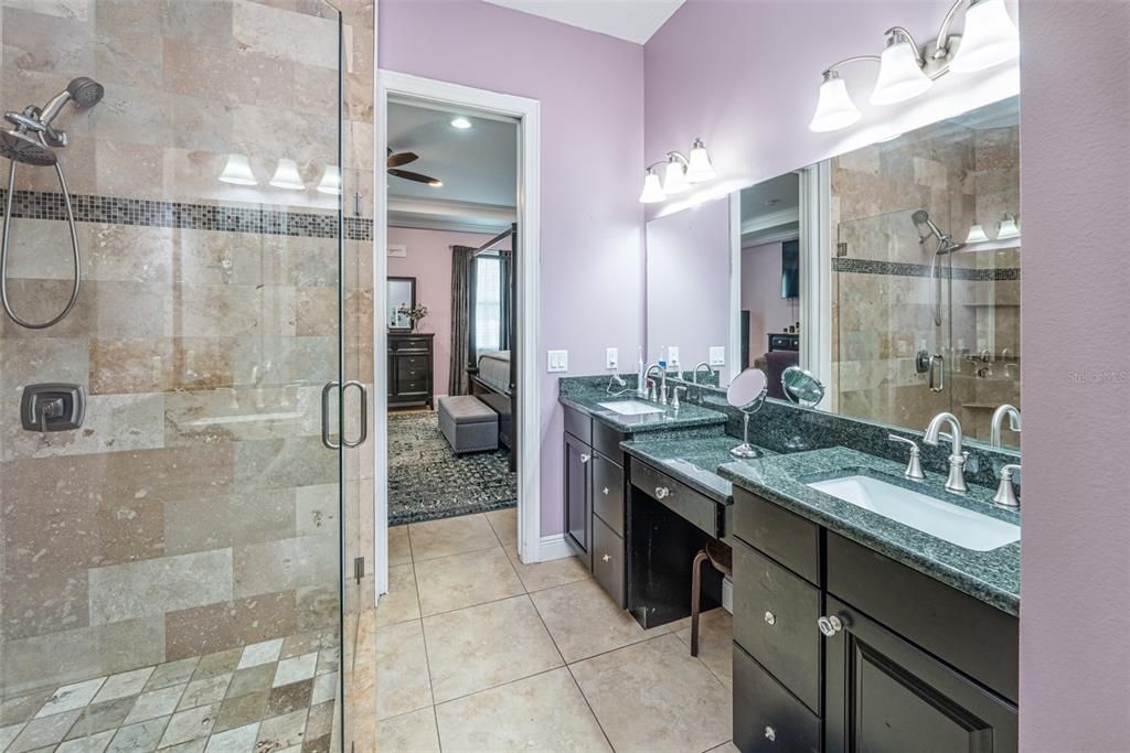 Granite counters with undermount sinks and a separate water closet.