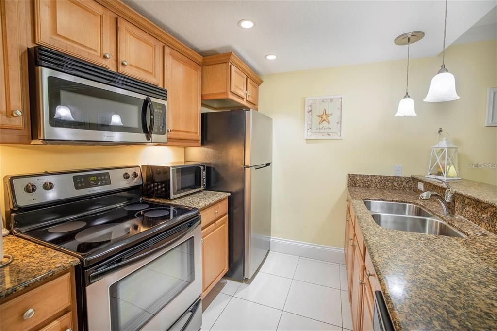 Full kitchen with stainless steel appliances and granite countertops