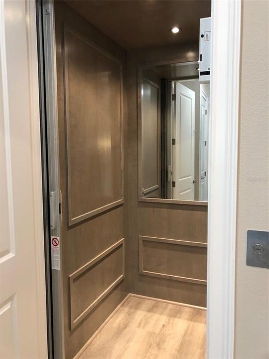 Custom elevator with mirror and LED lighting from Garage level to Living level..