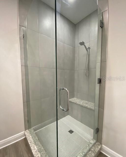 Owners shower with bench seat and frameless shower door