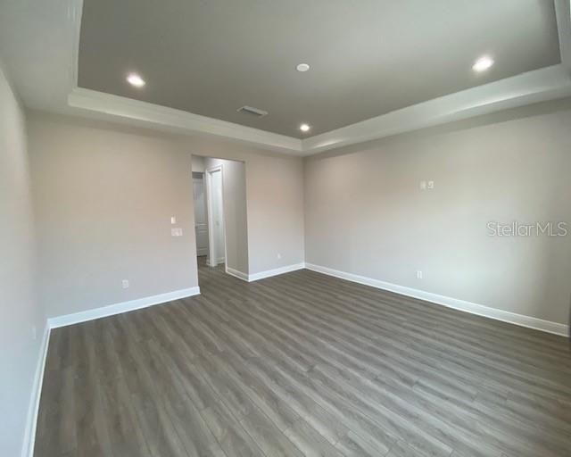 Owners bedroom with trey ceiling and dual walk-in closets