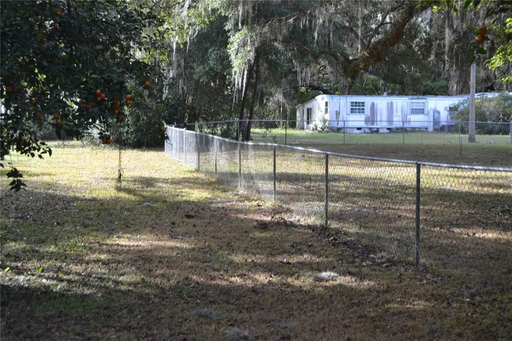 View from waterfront towards back of mobile - fenceline belongs to neighbor