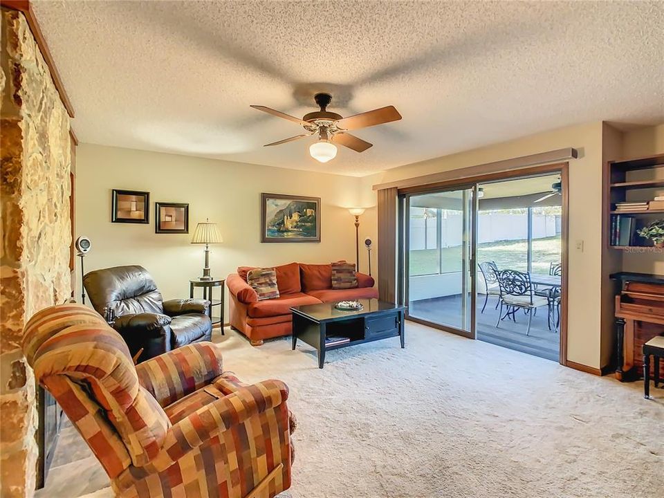 The family room is directly behind the living room and opens to the screened back patio.