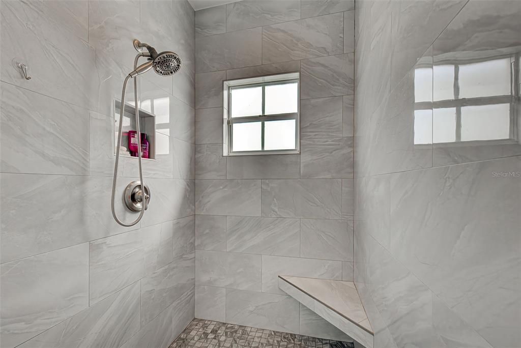 Master bathroom features a gorgeous, large Roman shower.