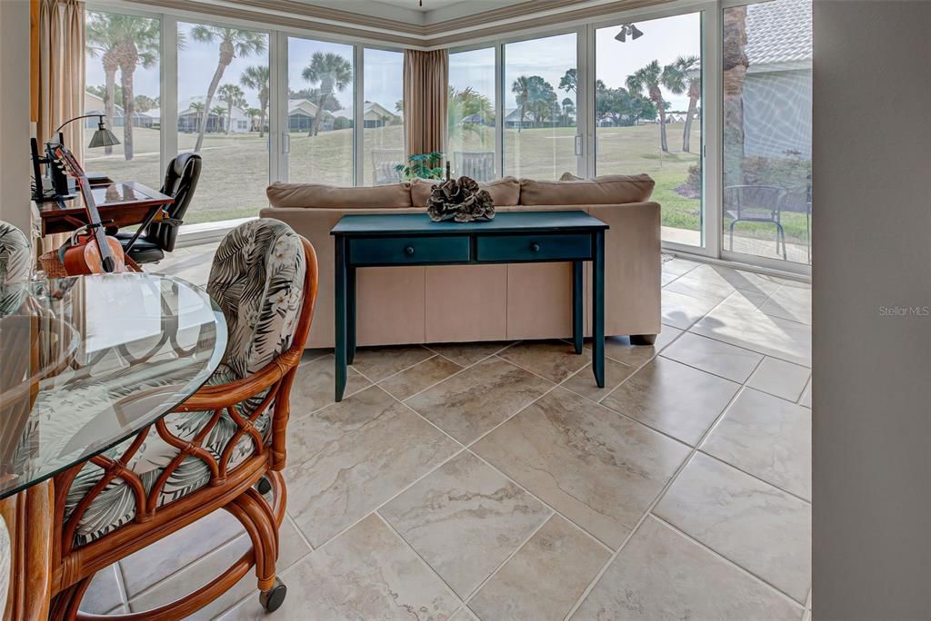 Airy and bright Florida room, just the perfect place to relax with a good book or laugh with friends.