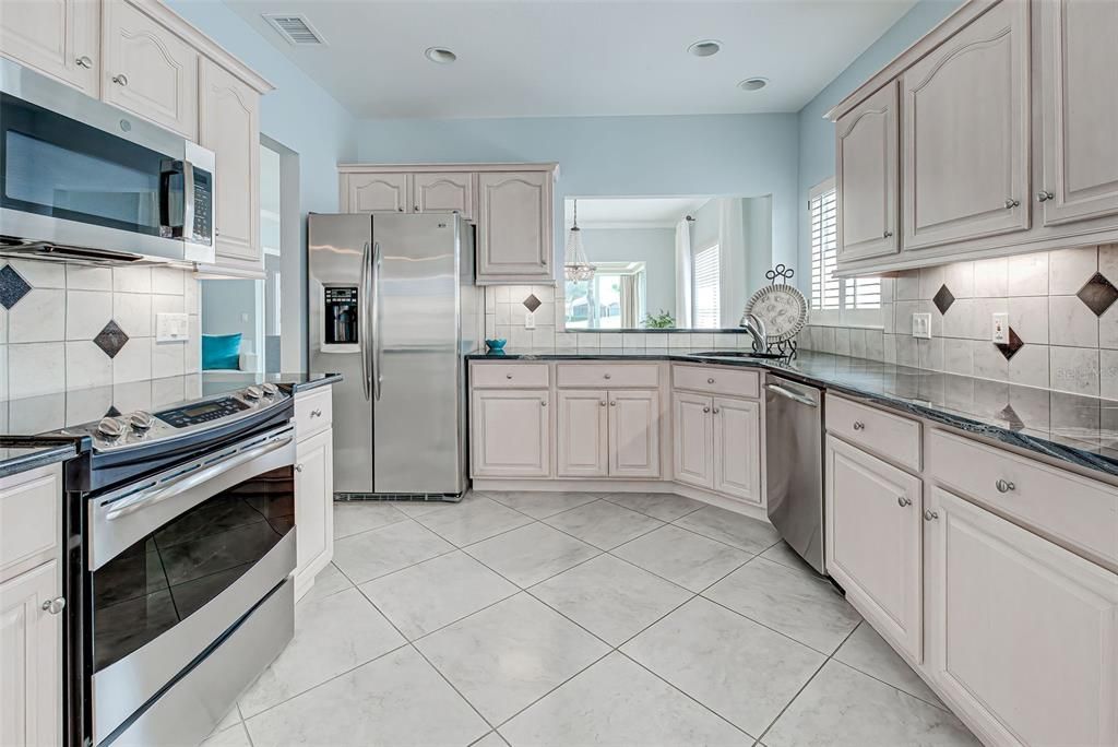 Gorgeous kitchen with newer SS appliances, diagonal tile and convenient pass through to the dining room.