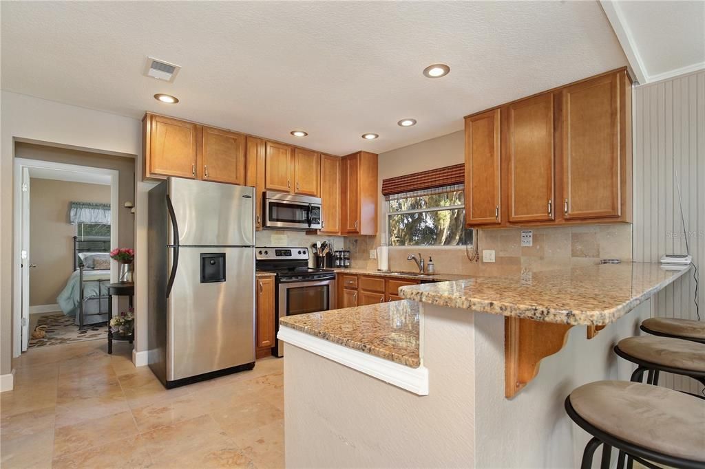 Updated kitchen with granite counters and stainless steel appliances
