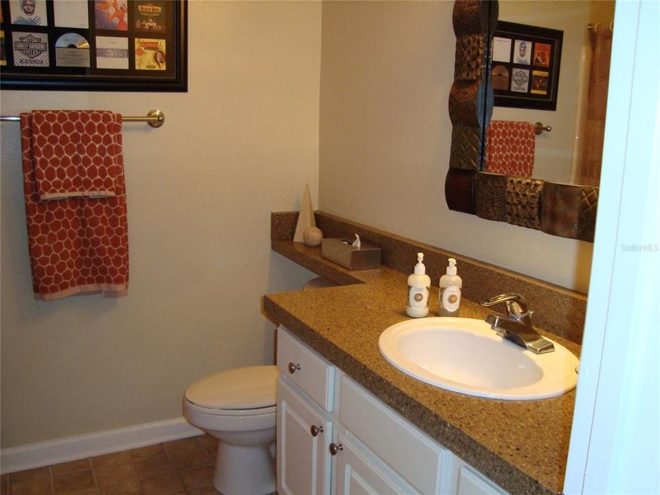 Guest bathroom with granite counter, shower and tub