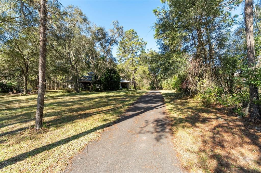 Paved driveway to home goes back thru to the street behind