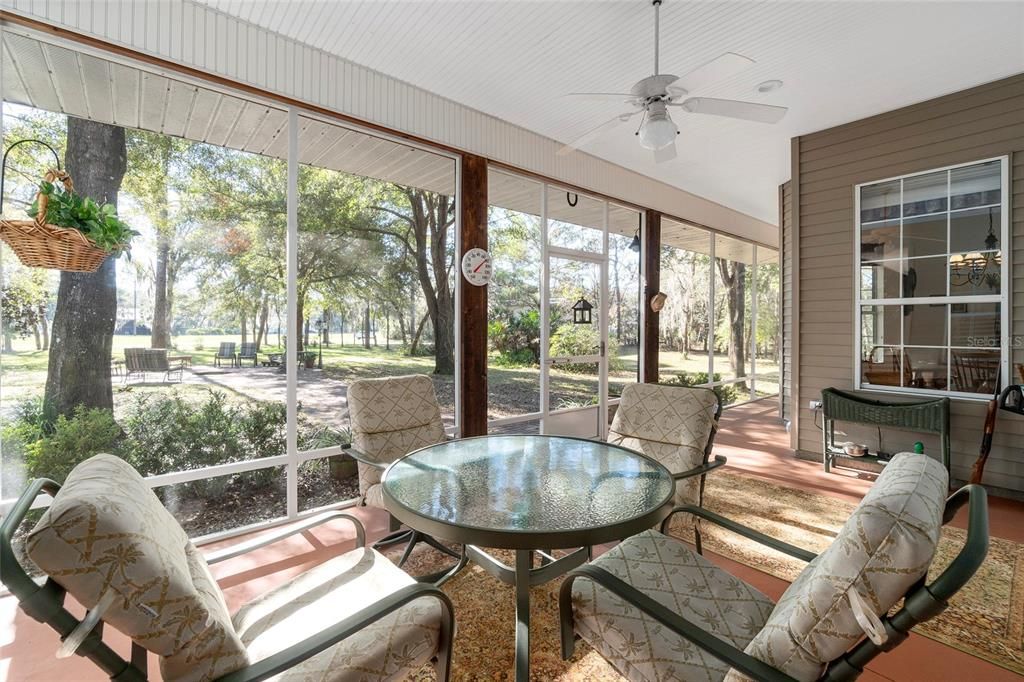 Screened front porch with view of runway.