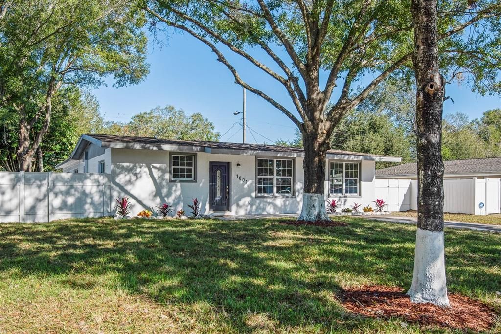 A welcoming home with a freshly sodded front lawn, new plants, and mature shade trees just trimmed! Exterior has been freshly painted and a brand new vinyl fence surrounds the back yard and home. Single gate on one side and a double door on other side.
