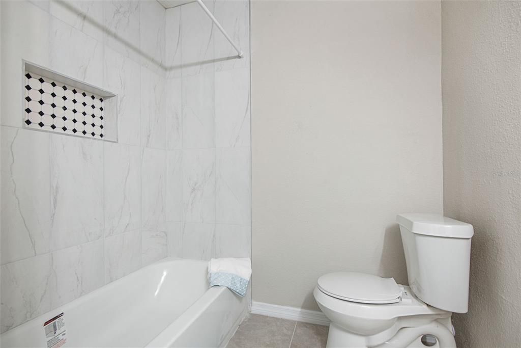 Full shower and tub combo in guest bath.