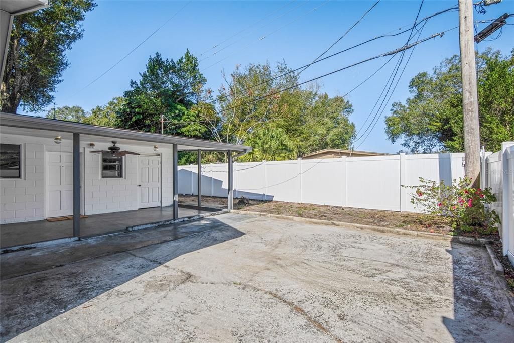Enter through double door fence gate. Patio in backyard outside kitchen and apt area. Great for storage of boat, RV, car, equipment. Play area!How about a pool area?!