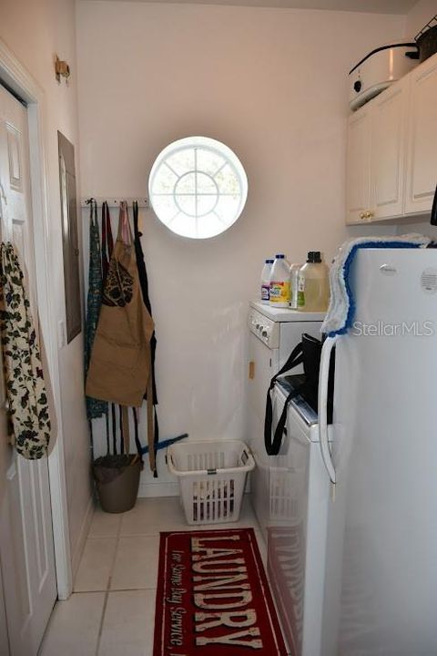 Laundry Room with closet and window