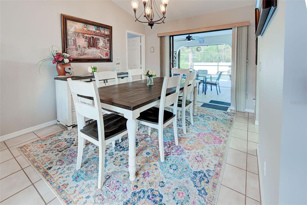 Entertain in the dining room, with view to the patio/pool